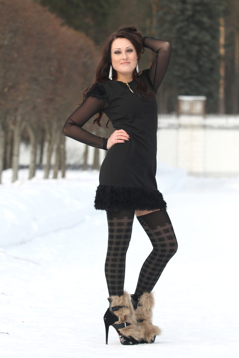 Full length portrait of pretty brunette woman in winter park