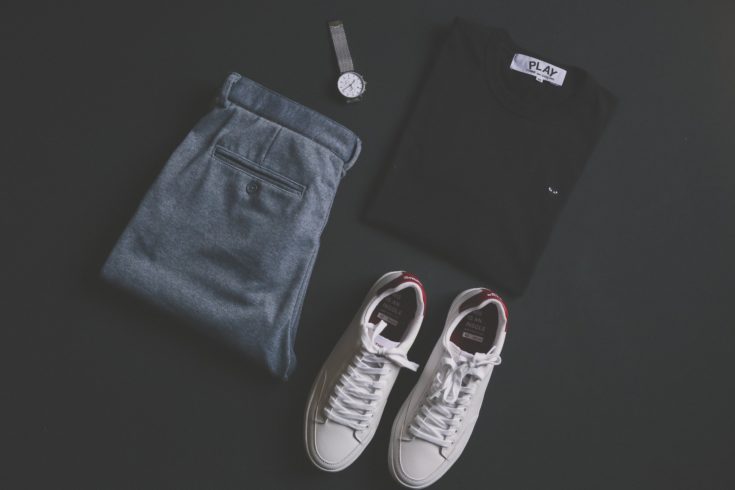 Mens white sneakers with gray slacks, black shirt and watch